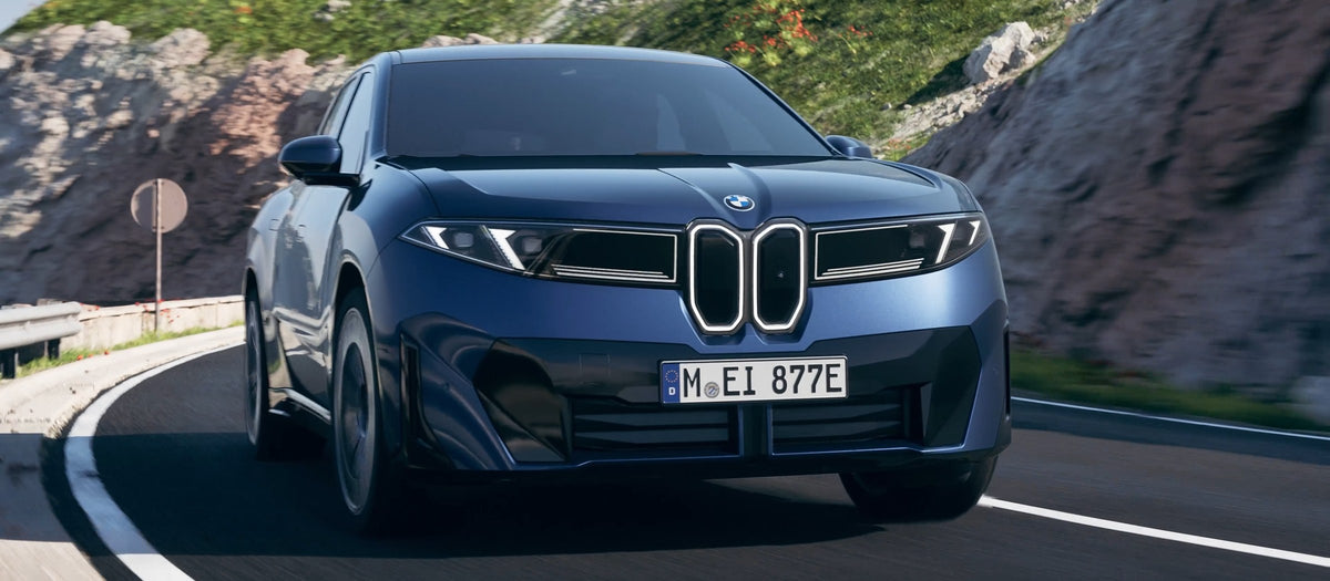 BMW iX3 50 xDrive em curva na estrada